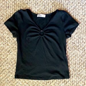 A soft black shirt with a metal ring in the front